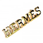 ブローチ・エルメス金色ロゴ文字 HERMES