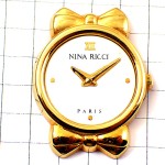 ピンバッジ・ニナリッチ腕時計リボン金色ゴールド NINA-RICCI